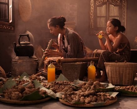 Seorang wanita tengah meracik ramuan obat tradisional Sunda dengan bahan-bahan alami, menunjukkan kearifan lokal yang diwariskan turun-temurun. Proses ini menggambarkan dedikasi dalam melestarikan praktik pengobatan nenek moyang untuk kesehatan dan kesejahteraan.