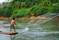 Para pekerja dan relawan secara aktif membersihkan sampah serta sedimen di salah satu titik Sungai Citarum, menunjukkan komitmen nyata dalam upaya restorasi lingkungan sungai legendaris ini. Pemandangan ini merefleksikan harapan baru bagi masa depan Citarum yang lebih bersih dan sehat.