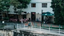 Seorang wanita melakukan yoga di rooftop dengan latar belakang gedung-gedung tinggi Jakarta, melambangkan upaya mencari ketenangan di tengah hiruk-pikuk kota metropolitan. Foto ini merefleksikan tren gaya hidup urban yang menyeimbangkan kesibukan dengan aktivitas relaksasi dan kesehatan.