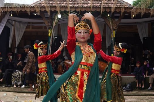 Seorang penari Jaipong dengan kostum warna-warni dan selendang yang melambai anggun, tengah menampilkan gerakan lincah penuh ekspresi, mencerminkan semangat khas tarian tradisional Sunda. Tarian ini memadukan kekuatan dan keanggunan, menjadi identitas budaya yang terus dijaga kelestariannya.